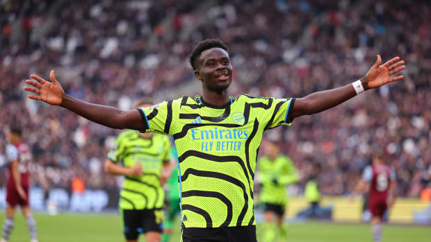 Bukayo Saka pictured celebrating after scoring two goals for Arsenal in a 6-0 win at West Ham in February 2024